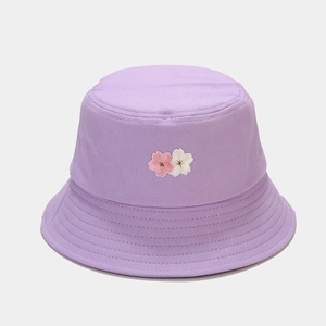 Detail of embroidered cherry blossoms on a purple cotton canvas bucket hat