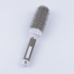 Detail of round hairbrush featuring nano ceramic technology and ionic thermal barrel