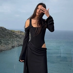 Slim fit black off-shoulder long sleeve bodysuit with wrap maxi skirt on seaside balcony