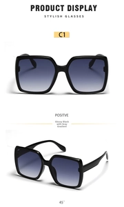 Macro view of C1 glossy black square sunglasses with grey gradient lenses at 45 degree angle