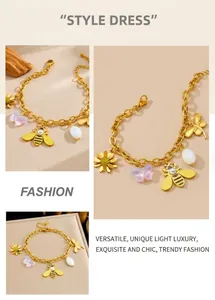 Detail of gold-plated chain bracelet with daisy, butterfly, and pearl bee charms