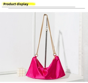 Detailed view of rose pink satin tote bag featuring premium metallic chain strap