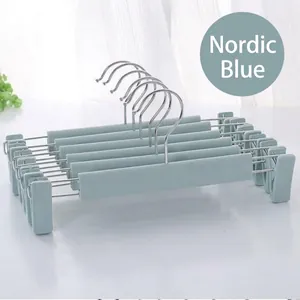 Close-up of ten Nordic blue non-slip plastic pants hangers with adjustable clips and metal hooks