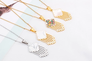 Detailed close-up of gold and silver hollowed heart pendants with marble inlay