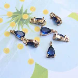 Detail view of 6 royal blue teardrop glass pendants with gold plated copper base for DIY jewelry