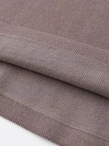 Close-up of fine-knit fabric texture and high-quality stitching on taupe sleeveless top