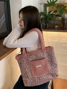 Pink leopard print canvas tote bag with fuzzy handles and large front storage pocket