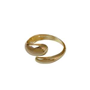 Minimalist gold-tone open cuff bracelet with sleek teardrop ends and polished finish