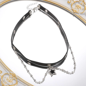 Detail of Y2K leather choker with silver stars and sparkling rhinestone heart on a mirror