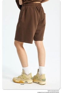 Detail of dark brown vintage cotton sweatpants with elastic drawstring waistband
