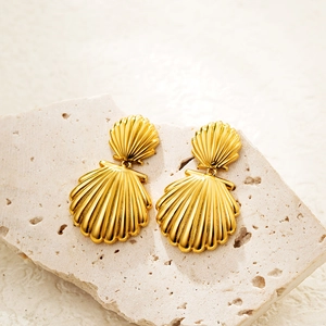 Chic 18K gold shell earrings with vertical striped texture on a textured stone