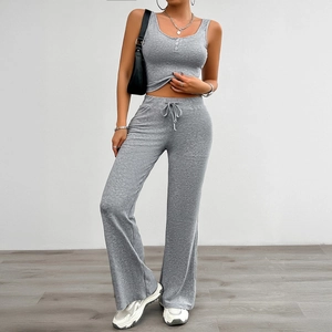 Women's grey yoga tracksuit featuring sleeveless vest and flared wide leg pants set