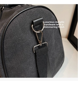 Close-up of durable silver metal hook and dark canvas texture with black leather edge