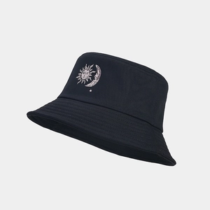 Detailed view of sun and moon embroidery on black cotton canvas bucket hat