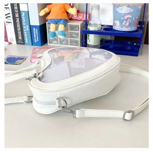 Close-up of white heart-shaped Ita bag featuring a clear window for badge display