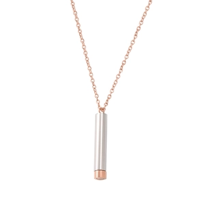 Close-up of dual-tone silver and rose gold cylindrical pendant necklace in stainless steel
