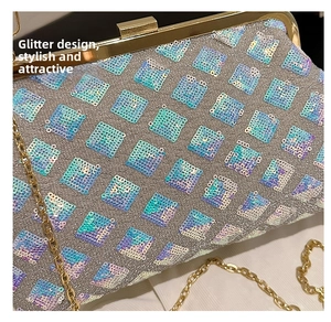 Macro detail of iridescent sequins diamond pattern and gold chain on the evening shell bag