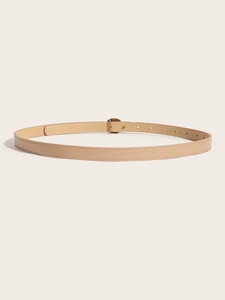 Close-up of light beige leather belt with visible stitching and a sleek metal buckle