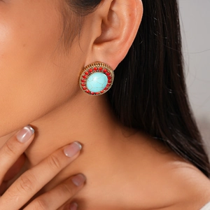 Macro shot of bohemian vintage stud earrings with turquoise stone and red rhinestones