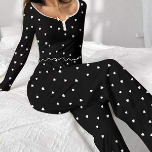 Women's black two-piece pajama set with white heart prints and delicate lace trim collar