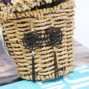 Detail of gothic spider web drop earrings with black hollow mesh and chain tassels