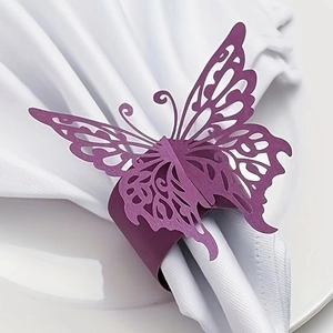 Detail of purple laser-cut butterfly paper napkin ring on a white table setting