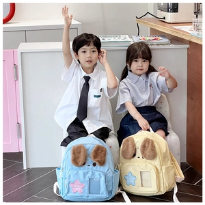 Detail of cute puppy backpacks with plush ears and star patches for kids