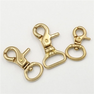 Detailed view of three polished solid brass lobster clasps for DIY leathercraft hardware