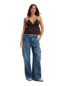 Women's blue wide-leg cargo jeans with large pockets and a brown lace-trim camisole