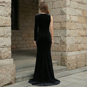 Detail of black velvet evening gown featuring a sleek one-shoulder design and fishtail hem