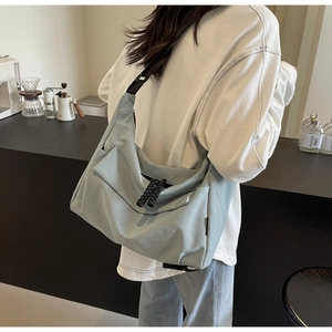 Lifestyle view of a large light blue tote bag with zipper and comfortable shoulder strap