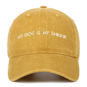 Detail of white embroidery MY DOG IS MY SHRINK on a mustard yellow washed cotton cap