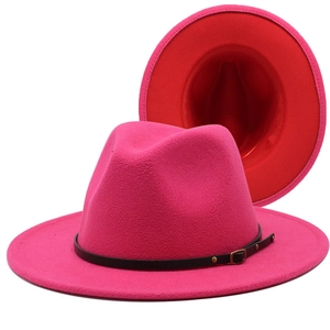 Detail of red fedora wool hat with black leather belt buckle and wide flat brim