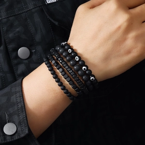 Detail of multi-layer handmade beaded bracelets with matte onyx and eye pattern beads