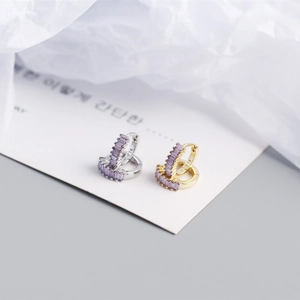 Detail of S925 sterling silver huggie earrings with purple zircon and 925 hallmark