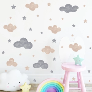 Detail of watercolor cloud and star wall stickers in beige and pink for a kid's room décor