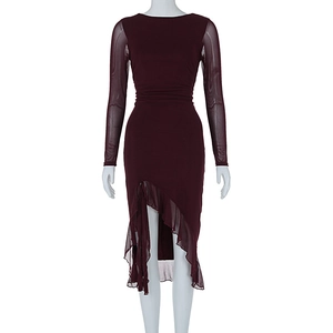 Detail of burgundy mesh patchwork sleeve and ruffled hem on elegant slim dress