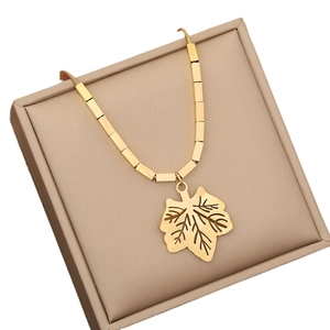 Minimalist gold-plated stainless steel necklace with a hollow leaf pendant in a jewelry box