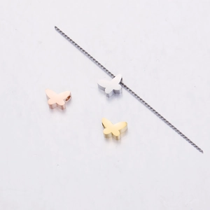 Three mirror polished butterfly charms in rose gold, silver, and gold stainless steel