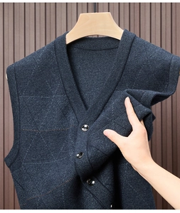 Detail of navy blue V-neck knitted vest showing fabric texture and black buttons