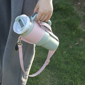 Detail of pink leather water bottle carrier with adjustable strap and key hook feature