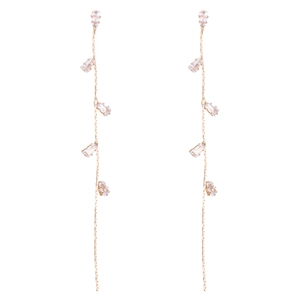 Macro detail of long gold tassel earrings featuring rectangular cubic zirconia stones