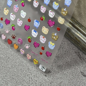 Detailed close-up of 5D embossed nail stickers featuring colorful cartoon bears and hearts