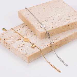 Elegant gold and silver cross bracelets with Virgin Mary charms on beige stone