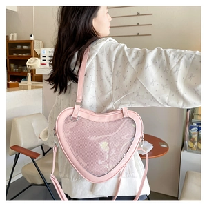 Pink heart-shaped lolita bag with a clear window shown worn on a model's back