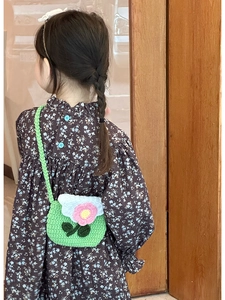Detailed crochet flower strap bag for kids on little model with green floral dress