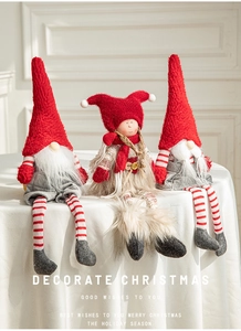 Three Christmas gnomes with red knit hats and long beards sitting on a table