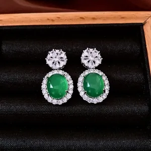 Vintage silver stud earrings featuring oval green emerald stones and zircon accents