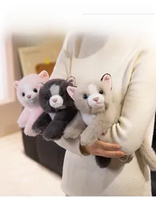 Close-up of three plush Persian cats with sapphire eyes in pink, dark gray and beige