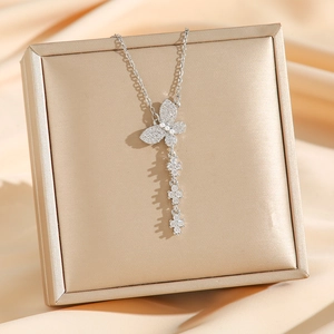 Silver butterfly necklace with zirconium pendant and tassel stars on champagne satin